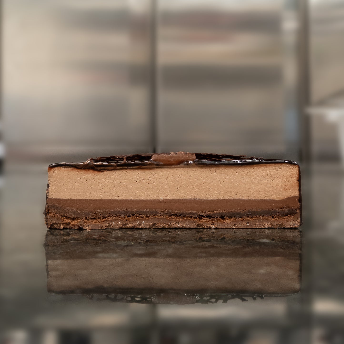 Cross section of the absolute chocolate cake. Layers of mousse, crémeux, biscuit and a crunchy base.