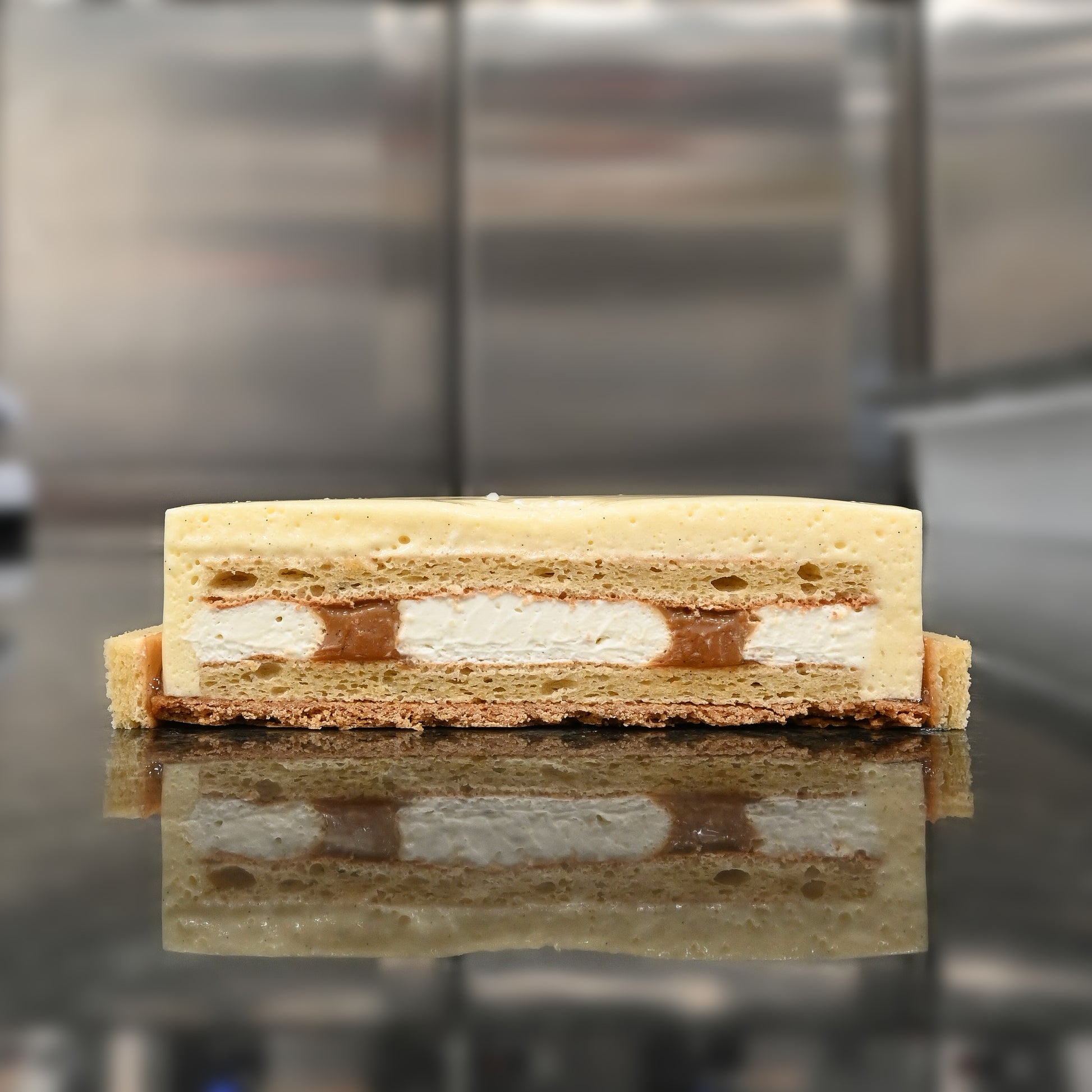 Vanilla Cake Cross Section - Layers of vanilla biscuit, caramel, sablé, and chiboust, creating a variety of textures and flavors in every bite.