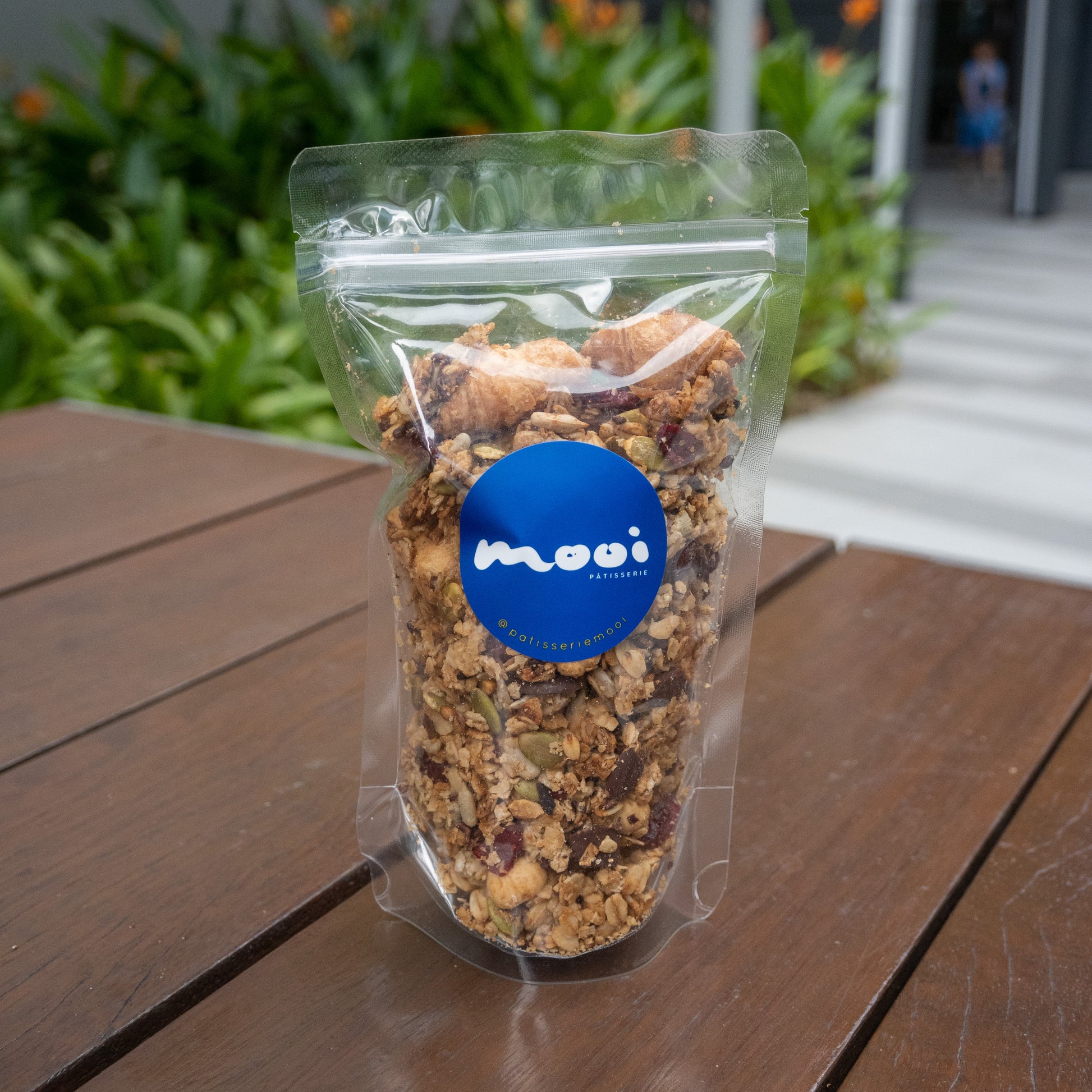 House-made granola with nuts, seeds, dried fruits and mini croissants served in a bag.