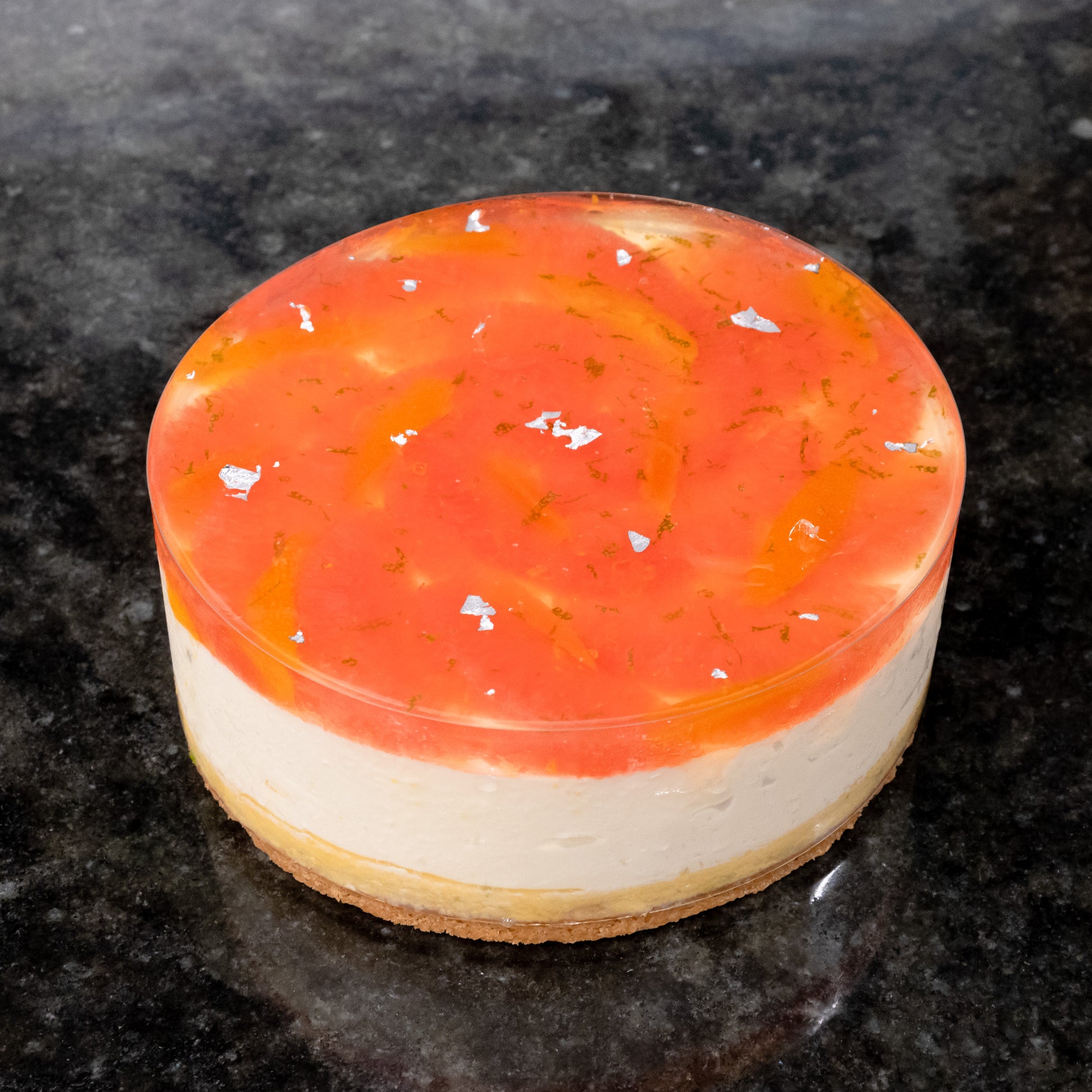 Layered cake with sablé Breton and lime sponge on the bottom, fromage blanc mousse in the middle, and grapefruit Timur pepper.