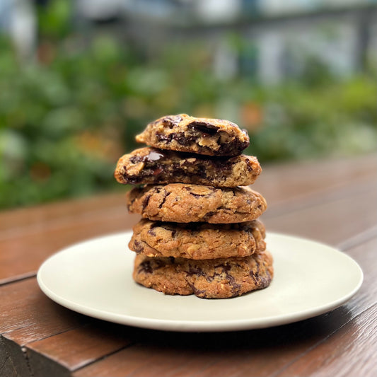 Stack of Hazelnut Chocolate Chip Cookies made with Valrhona Guanaja 70% chocolate and hazelnuts, crispy edges with a chewy center